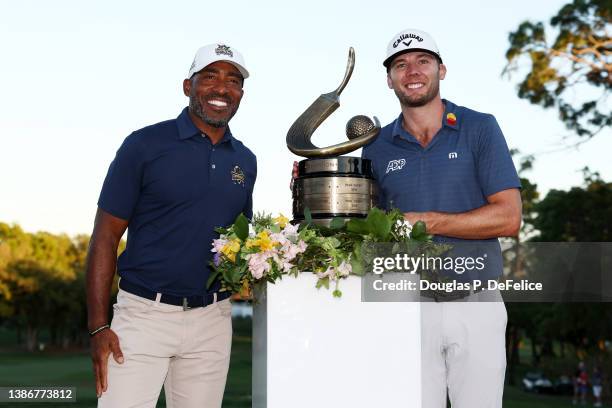 Sam Burns of the United States celebrates with former NFL player Ronde Barber and the trophy after defeating Davis Riley of the United States during...