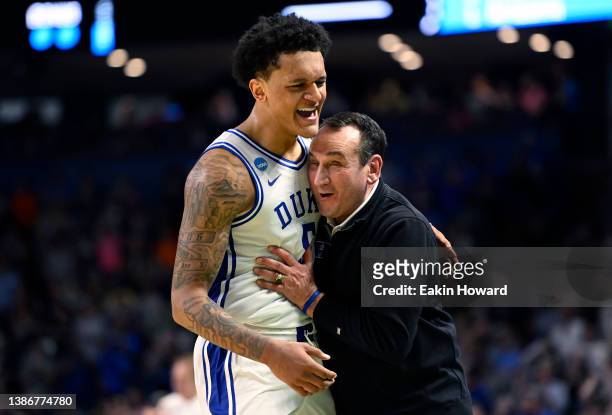 Paolo Banchero and head coach Mike Krzyzewski of the Duke Blue Devils embrace after defeating the Michigan State Spartans 85-76 during the second...