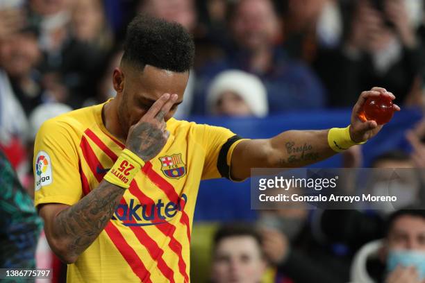 Pierre-Emerick Aubameyang of FC Barcelona celebrates scoring their fifth goal with a glass ball during the LaLiga Santander match between Real Madrid...