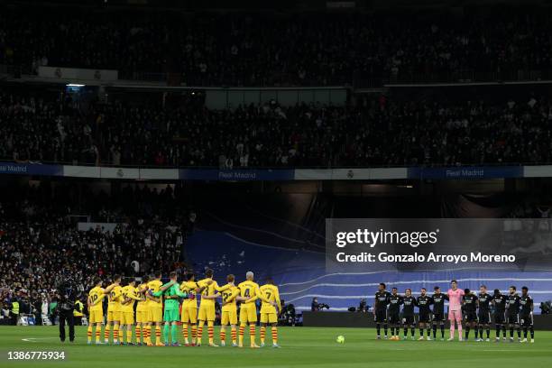 Real Madrid R) and FC Barcelona players observe one minute of silence in memory of deceased ex FC of FC Barcelona president Raimon Carrasco prior to...