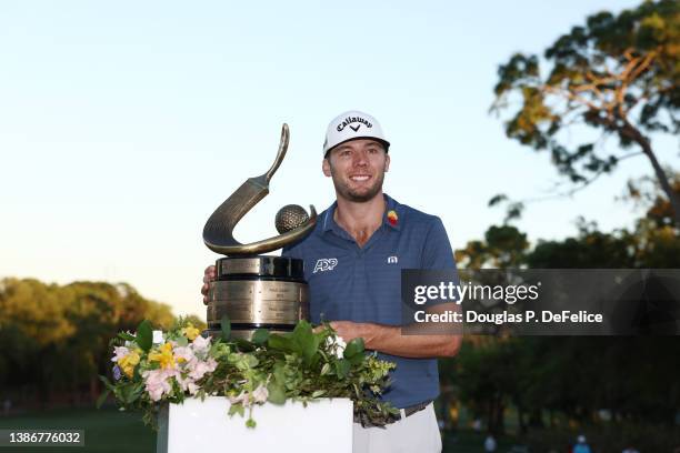 Sam Burns of the United States celebrates with the trophy after winning during a playoff in the final round of the Valspar Championship on the...