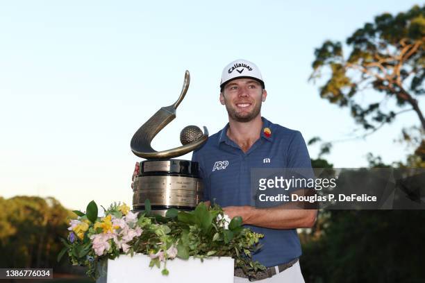 Sam Burns of the United States celebrates with the trophy after winning during a playoff in the final round of the Valspar Championship on the...