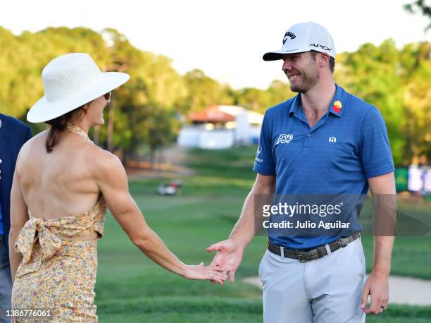 Sam Burns of the United States celebrates with his wife Caroline Campbell after defeating Davis Riley of the United States during a playoff in the...
