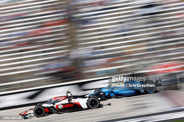 David Malukas, driver of the HMD Honda, and Jimmie Johnson, driver of the Carvana Chip Ganassi Racing Honda, drive during the NTT IndyCar Series XPEL...