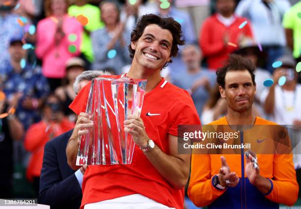 Taylor Fritz of the United States holds his winners trophy after his straight sets victory against Rafael Nadal of Spain in the men's Final on Day 14...