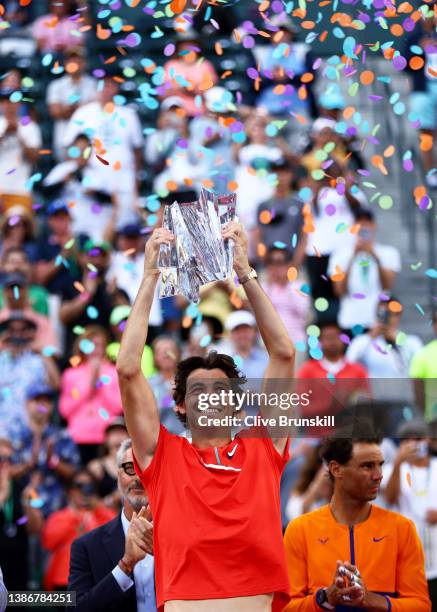 Taylor Fritz of the United States holds his winners trophy aloft after his straight sets victory against Rafael Nadal of Spain in the men's Final on...