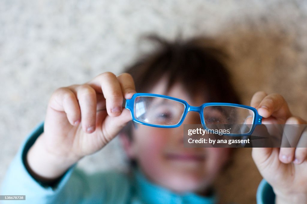 Boy looking from glasses