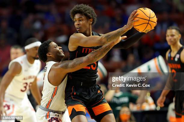 Johnson of the Auburn Tigers defends Kameron McGusty of the Miami Hurricanes in the second half during the second round of the 2022 NCAA Men's...