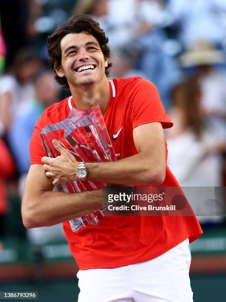 Taylor Fritz of the United States holds his winners trophy aafter his straight sets victory against Rafael Nadal of Spain in the men's Final on Day...