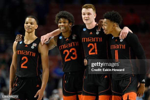 Isaiah Wong, Kameron McGusty, Sam Waardenburg and Jordan Miller of the Miami Hurricanes huddle in the second half against the Auburn Tigers during...