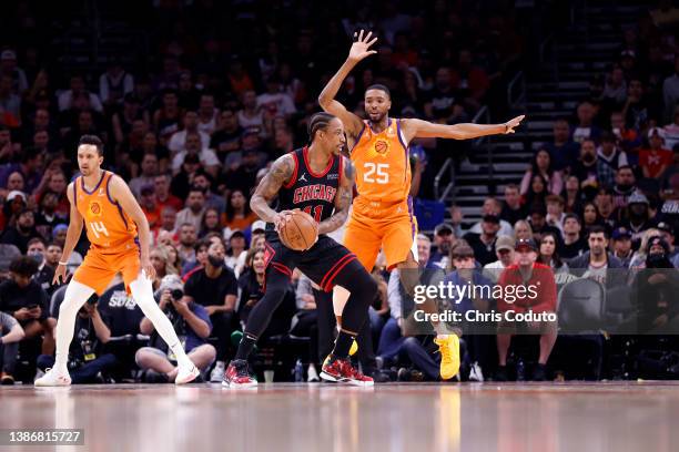 Mikal Bridges of the Phoenix Suns defends DeMar DeRozan of the Chicago Bulls during the first half at Footprint Center on March 18, 2022 in Phoenix,...