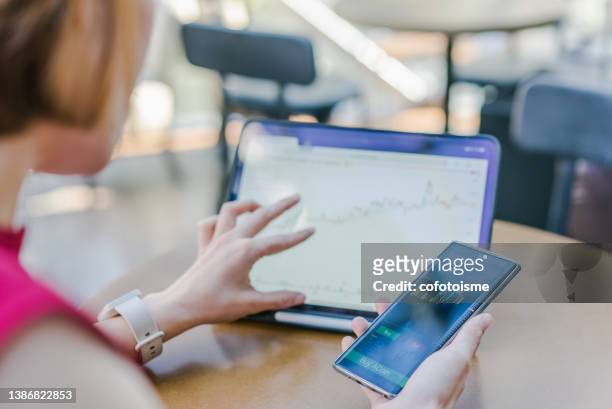 close up a woman using smartphone buy cryptocurrency at a coffee shop, blockchain investment, decentralize and stock market concept - lady wallet stock pictures, royalty-free photos & images
