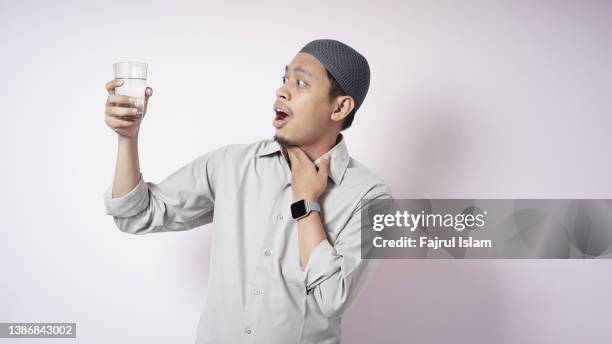 very thirsty when fasting on ramadan - indonesians prepare for the holy month of ramadan foto e immagini stock