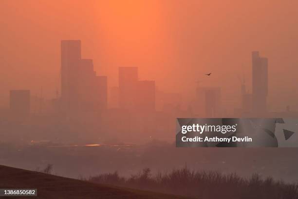 The skyline of the city of Manchester is seen at sunset on the Vernal Equinox, the astronomical first day of Spring on March 20, 2022 in Manchester,...