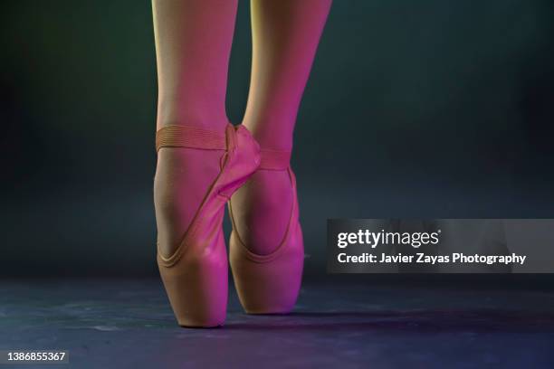 low section of ballet dancer woman dancing on dark stage - ballet feet hurt stock pictures, royalty-free photos & images