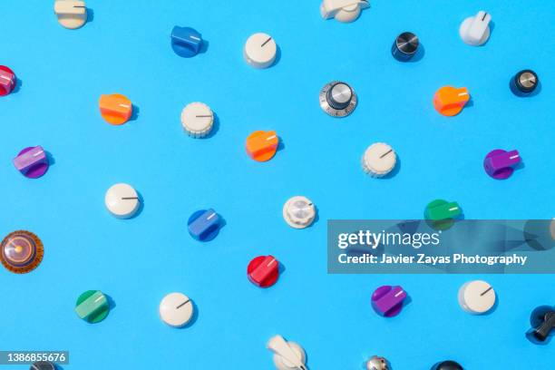 many multi colored knobs on blue background - button concept stock pictures, royalty-free photos & images