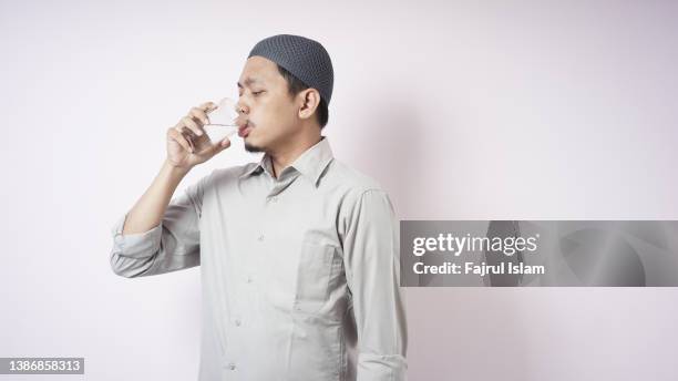 very thirsty when fasting on ramadan - indonesians prepare for the holy month of ramadan foto e immagini stock