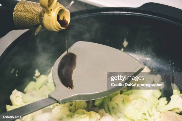 stir fry cauliflower  cooking - soy sauce stock pictures, royalty-free photos & images