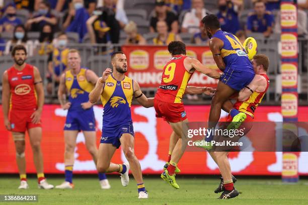 Willie Rioli of the Eagles collides with Matt Rowell of the Suns in a marking contest during the round one AFL match between the West Coast Eagles...