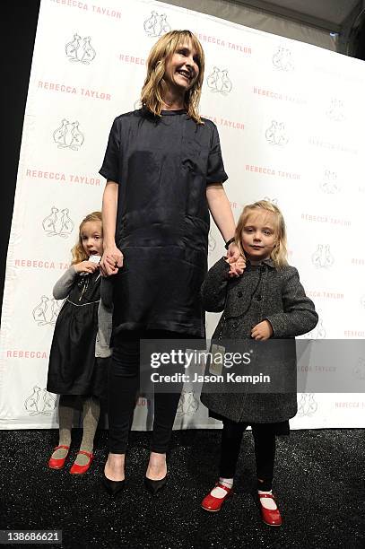 Designer Rebecca Taylor is greeted by her two daughters backstage at the Rebecca Taylor Fall 2012 fashion show during Mercedes-Benz Fashion Week at...