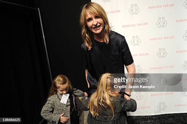 Designer Rebecca Taylor is greeted by her two daughters backstage at the Rebecca Taylor Fall 2012 fashion show during Mercedes-Benz Fashion Week at...