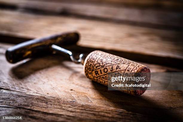 rioja wine cork stopper on rustic table - bottle stopper stock pictures, royalty-free photos & images