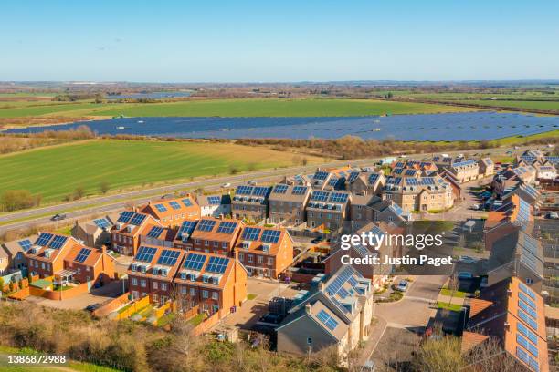 drone view of a new housing development with solar panels - sustainable living - urban housing stock pictures, royalty-free photos & images