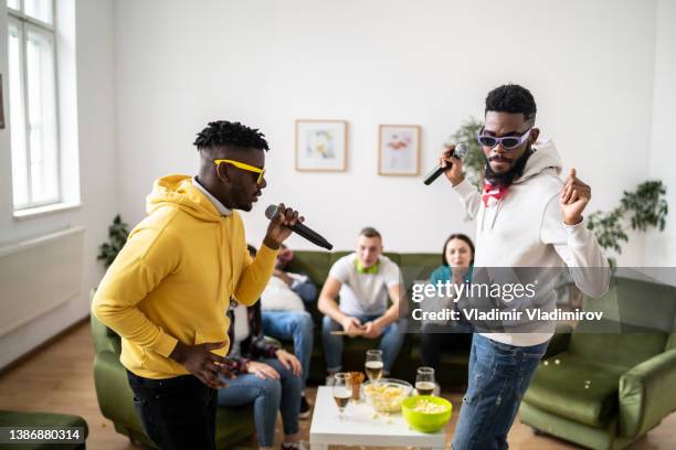 two friends singing and having fun - white rapper stock pictures, royalty-free photos & images