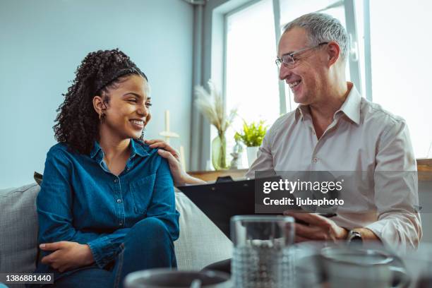 mature man talking with participants in a group therapy session - addiction recovery stock pictures, royalty-free photos & images