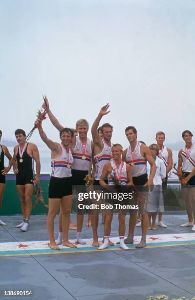 The British coxed four rowing team posed with their medals after finishing in first place to win the gold medal in the final of the Men's coxed four...