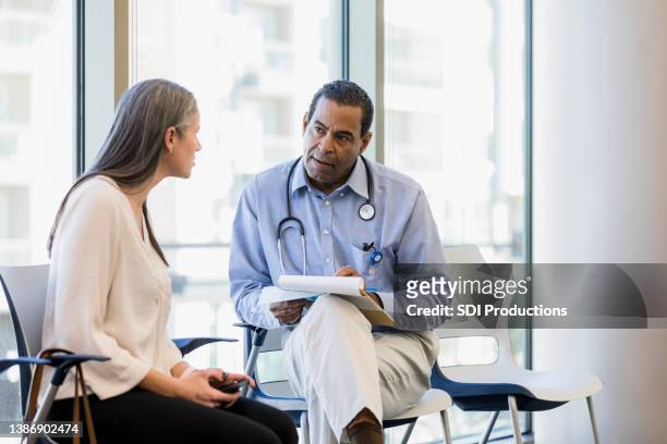 physician listens to the new staff member - mature adult with doctor stock pictures, royalty-free photos & images