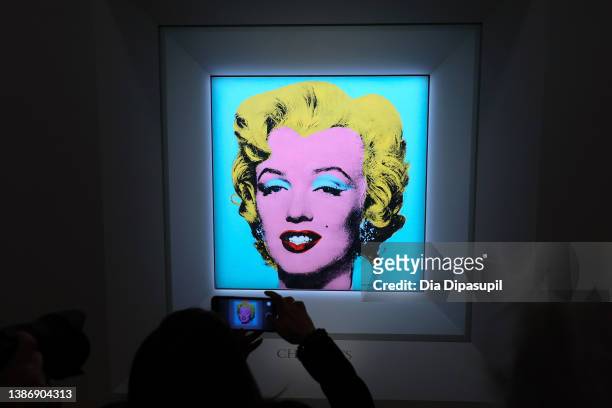 Guest takes a photo during Christie's announcement that they will offer Andy Warhol’s Shot Sage Blue Marilyn painting of Marilyn Monroe at Christie’s...