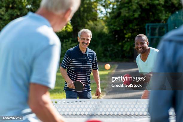 i've got this one! - friends table tennis stock pictures, royalty-free photos & images