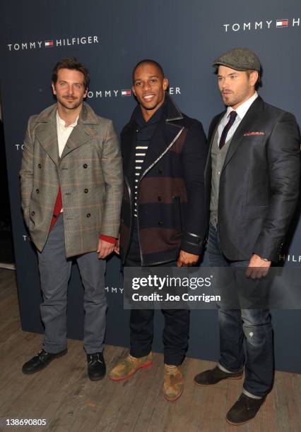 Bradley Cooper, New York Giants wide receiver Victor Cruz, and Kellan Lutz pose backstage at the Tommy Hilfiger Men's Fall 2012 fashion show during...