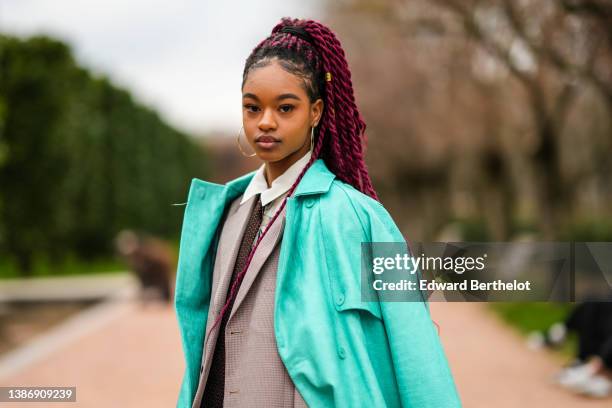 Debbie @blackhey wears silver earrings, a gold hair ring, a white shirt with embroidered multicolored pattern, a brown with white small polka dots...