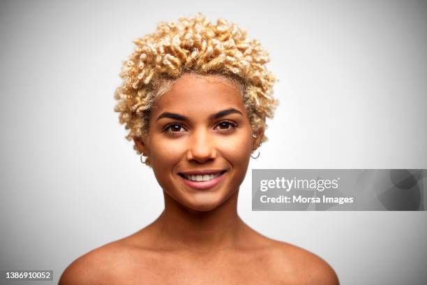 happy african american woman with blonde afro hair against white background - short brown hair stock pictures, royalty-free photos & images