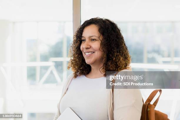 educator looks away for her headshot - student visa stockfoto's en -beelden