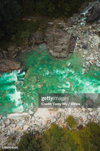 green water,high angle view of rocks by sea,switzerland - kanton tessin stock pictures, royalty-free photos & images