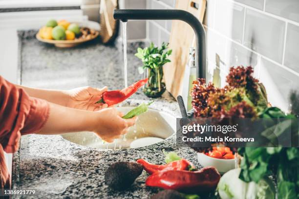 close up of woman's hands washing a paper. - delicious ストックフォトと画像