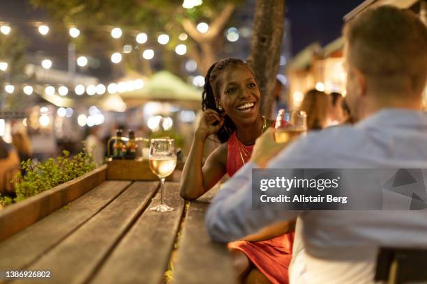 couple drinking wine together outdoors at night - rooftop at night bildbanksfoton och bilder