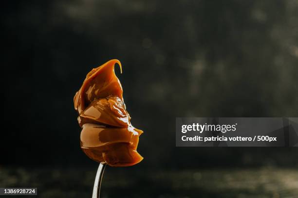 spoon of dulce de leche from argentina - dulce de leche stock pictures, royalty-free photos & images