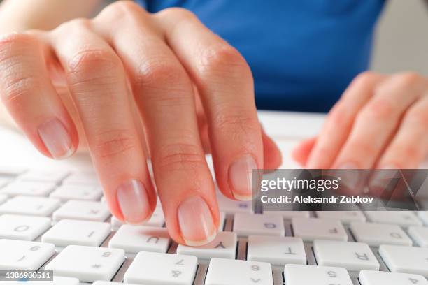 women's hands type text on the keyboard of a computer or laptop. an office worker at his desk. the concept of business, freelancing, working at home. - human finger print stock pictures, royalty-free photos & images