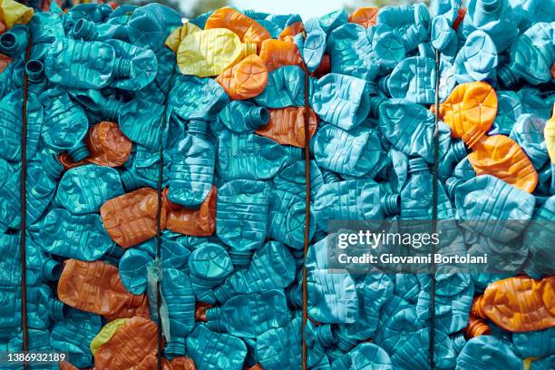 waste, compacted colored plastic bottles - plastic foto e immagini stock