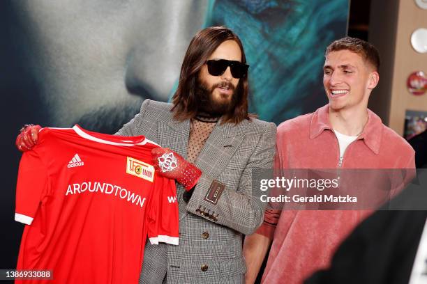 Jared Leto holds up a jersey of football club '1.FC Union Berlin' next to player Grischa Proemel attends a Special Fan Screening of Columbia...