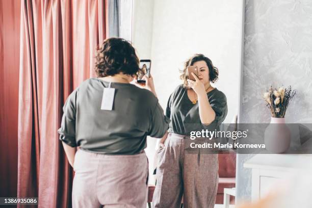 plus size woman choose fashioned dress in store. plus size women shopping. - big fat white women stock pictures, royalty-free photos & images