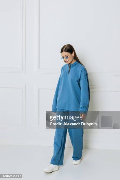 beautiful young woman model posing in studio in new clothes collection - track suit stock pictures, royalty-free photos & images