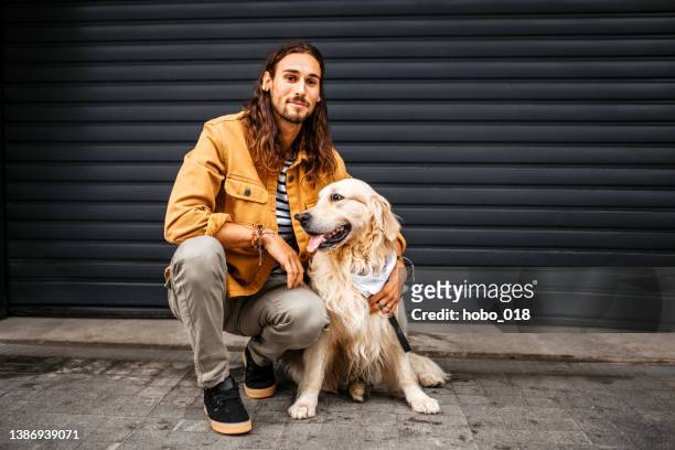 young man and his dog posing for a photo, looking at camera. - millennial generation stock pictures, royalty-free photos & images