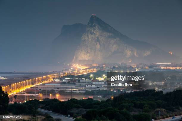 gibraltar rock and la linea de la conception at night (spain and gibraltar/ uk) - la linea de conception stock pictures, royalty-free photos & images