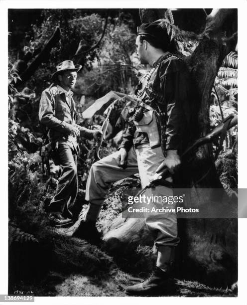 Frank Sinatra and Richard Johnson portray leaders of a United States Army guerilla band in tense, exciting Burma jungle battle scenes from the film...