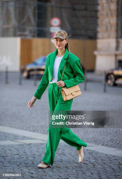 Mandy Bork is seen wearing green cropped Blazer & pants Storets, shoes María Luca, beige Chanel bag, cap Gucci on March 17, 2022 in Berlin, Germany.